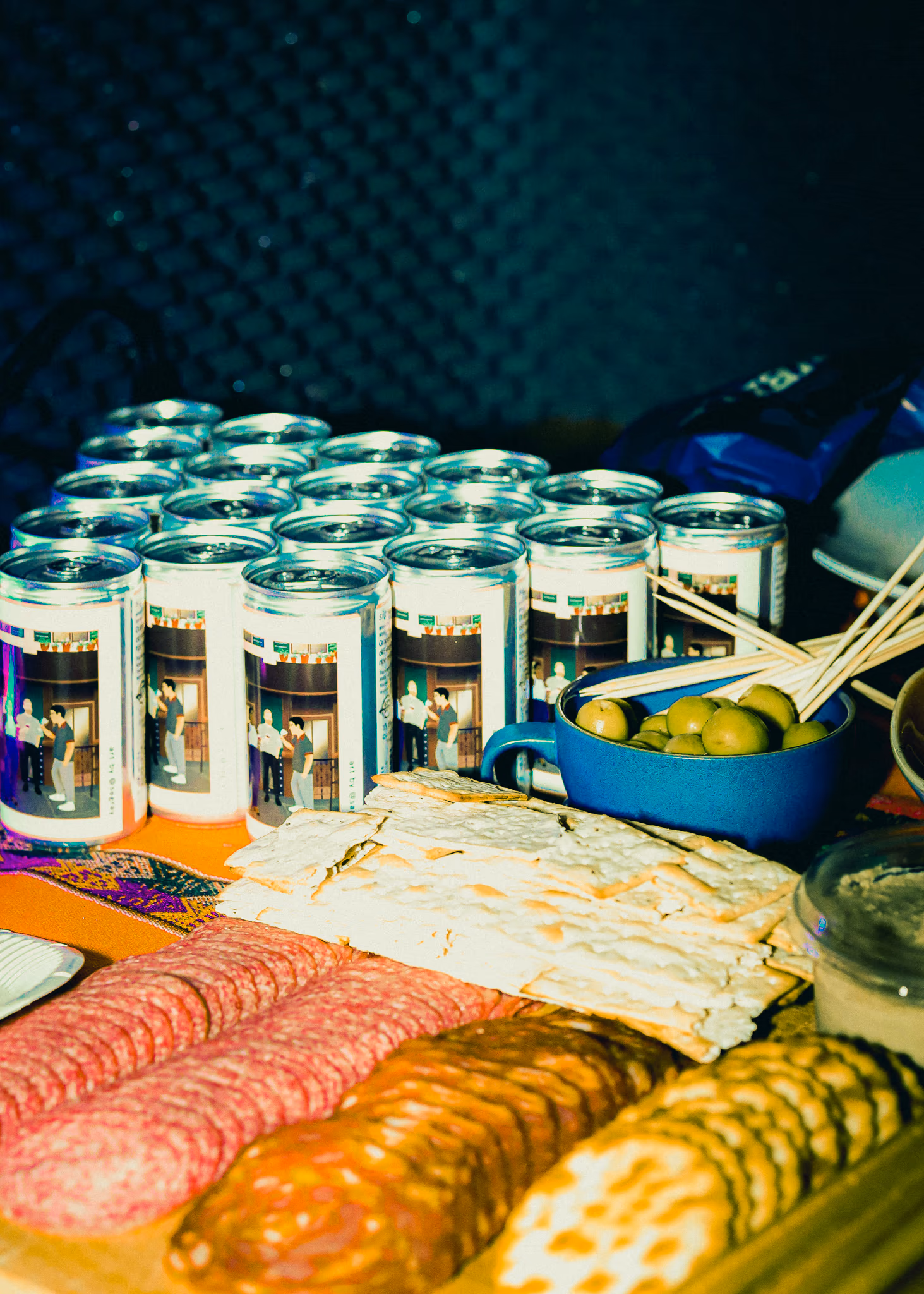 Stacked SIP cans alongside a charcuterie board